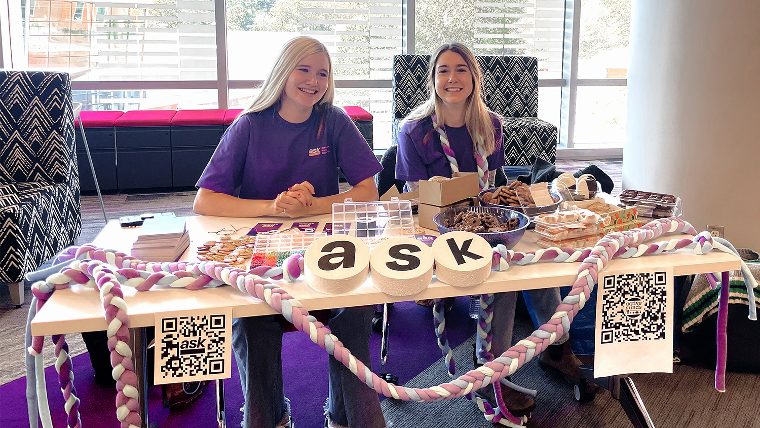 Two students sit at an arts and crafts table as part of the Active Minds organization