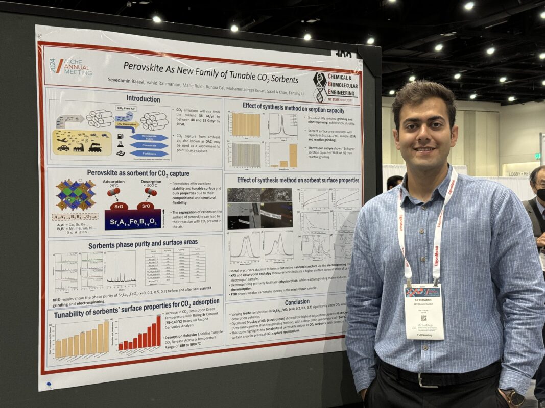 Man wearing a collared shirt standing next to his research poster