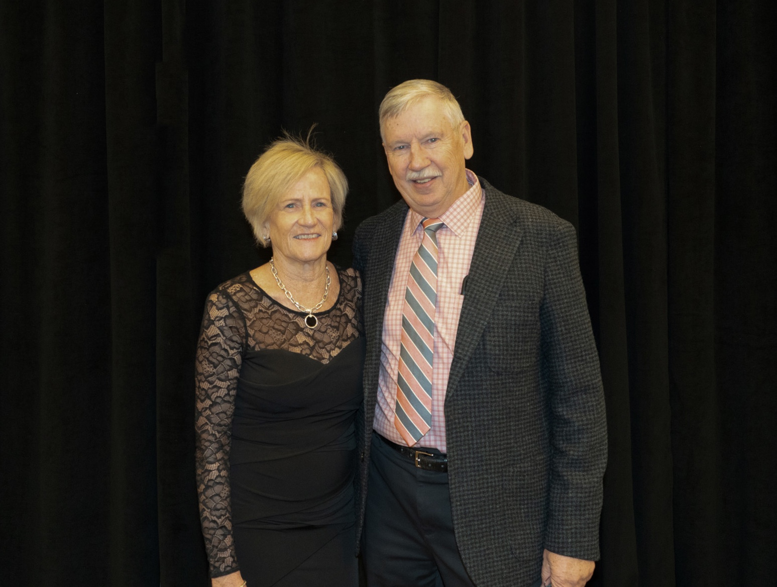 man and woman wearing formal attire smiling