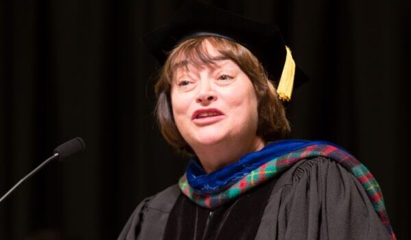 Lisa Bullard wearing graduation attire delivering an address