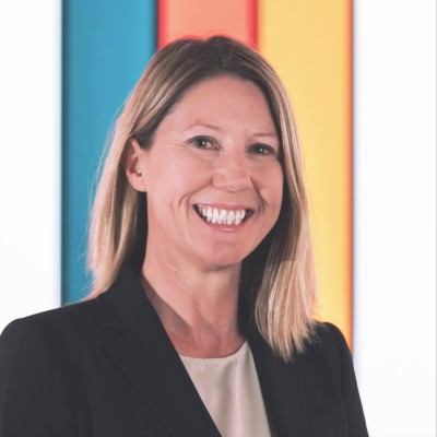 blonde woman wearing black blazer smiling