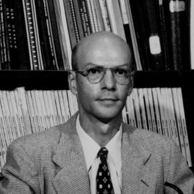 Edward Schoenborn in his office wearing a suit and glasses.