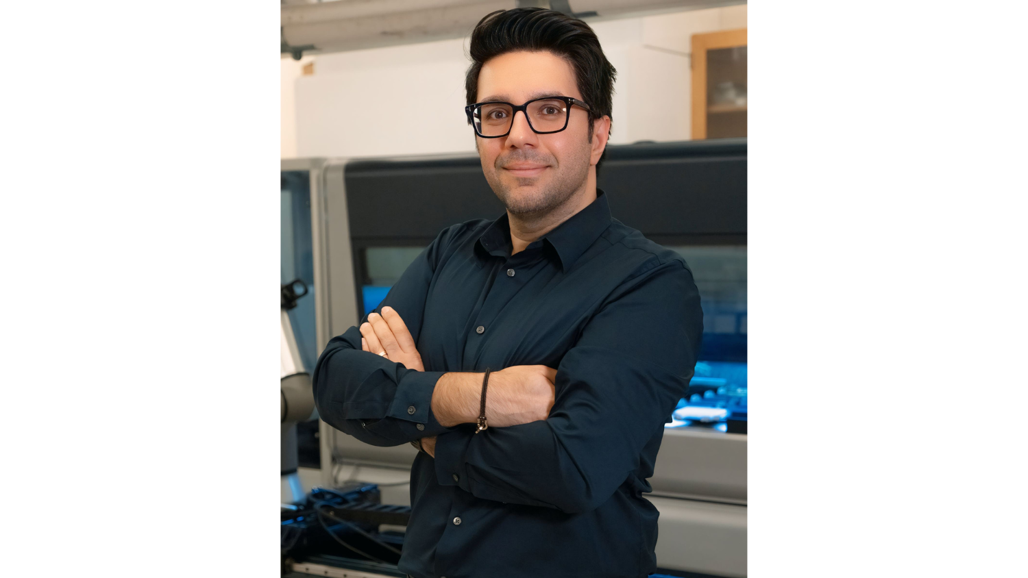 Milad Abolhasani poses inside his lab for a picture