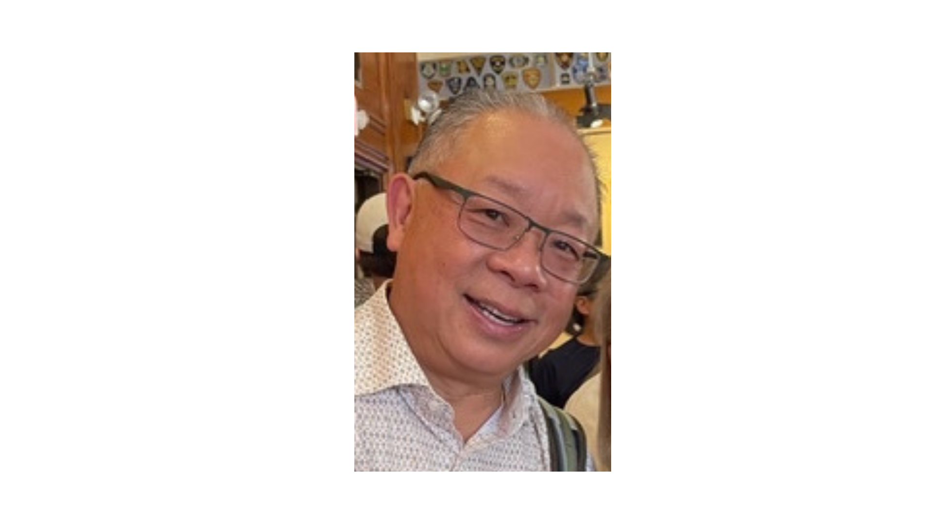bald man wearing glasses and a collared shirt