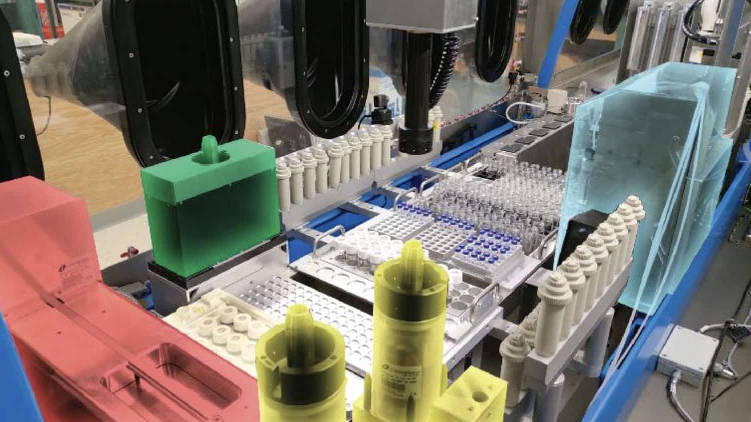 photo shows an array of colored cubes and test tubes connected by tubing. It is the hardware for the flex-cat system
